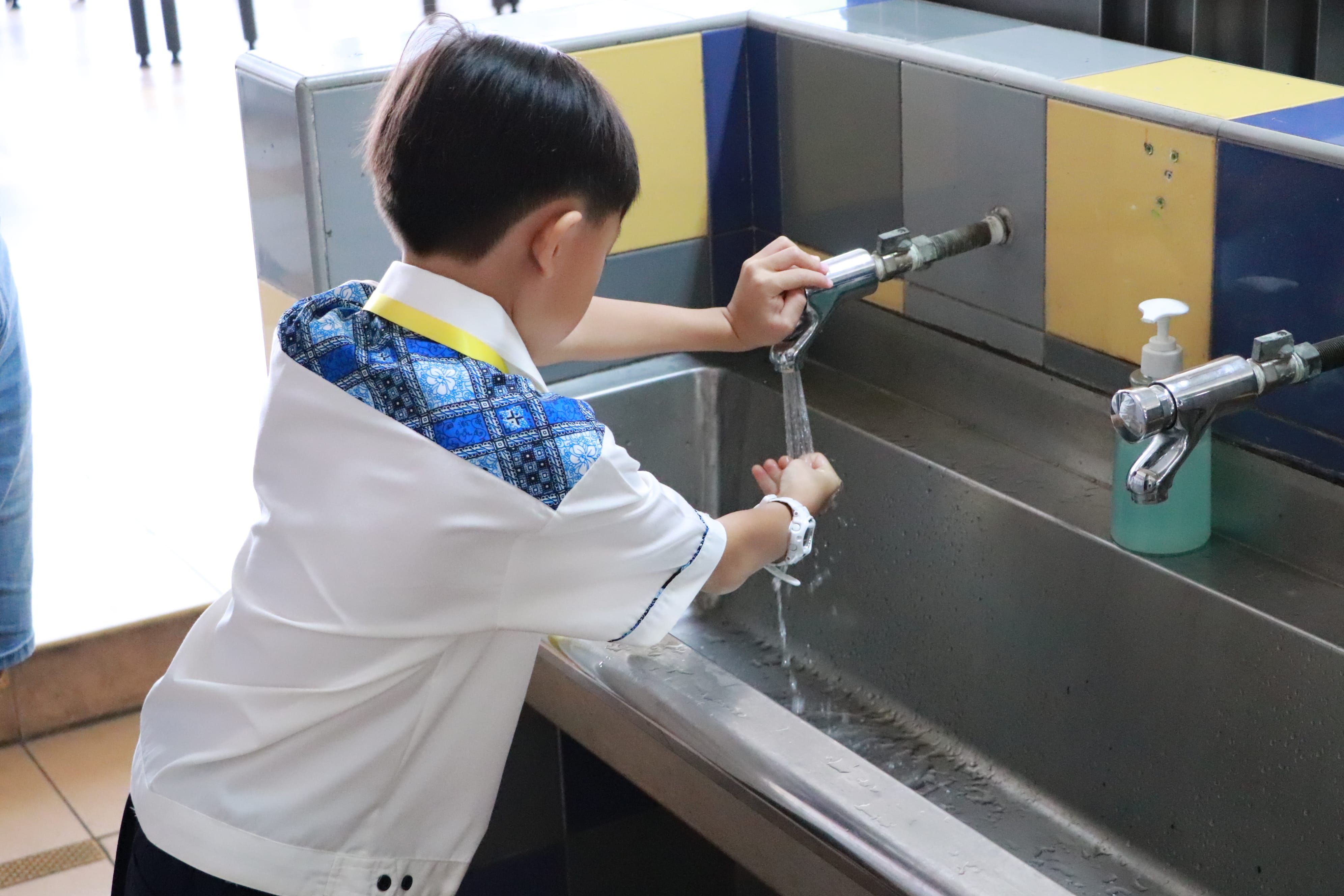 Picture of a student washing hand during recess time